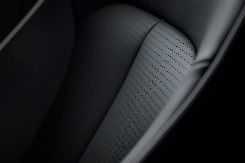Manufacturer close-up of perforated upholstery in the JAECOO 5 family